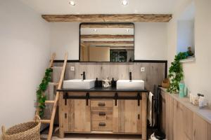 a bathroom with two sinks and a mirror at kernsaniertes Ferienhaus Anna in Durlangen +25 photos