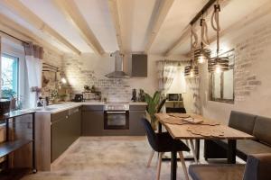 a kitchen and dining room with a table and chairs at kernsaniertes Ferienhaus Anna in Durlangen