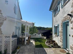 a patio of a house with a table and chairs at kernsaniertes Ferienhaus Anna in Durlangen