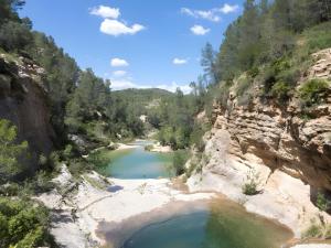 a river in the middle of a rocky canyon at Casa Rural San Antón in Quesa +7 photos