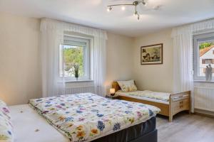a bedroom with a bed and a window at Mentel´s Ferienwohnung in Knüllwald