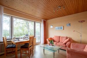 a living room with a couch and a table at Vogelhus Yvonne Vogel in Pellworm +15 photos