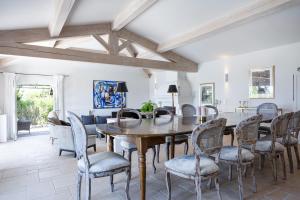 a dining room with a wooden table and chairs at Golfvilla Riviera in Grimaud