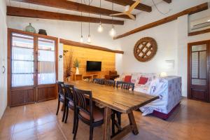 a dining room with a wooden table and chairs at Can Negri - Almadraba in El Port