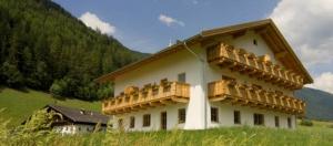 a building with balconies on the side of it at Apartment Bärental - Gruberhof in San Giacomo
