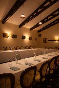 a long table in a room with chairs at Classic Inn Hotel in Braşov