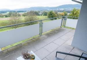 a balcony with a view of the water at Wohnung im Rheintal in Küssaberg