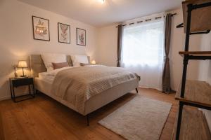 a bedroom with a large bed and a window at Wohnung im Rheintal in Küssaberg