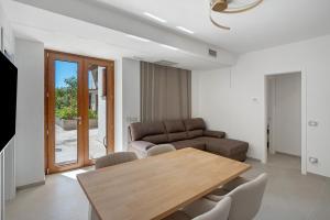 a living room with a wooden table and a couch at Residence Sulla Costa in Agerola