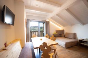 a living room with a couch and a table at Sonnleiten Sterngucker 10 in Collepietra