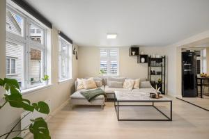 a living room with a couch and a table at Harmony Apartments - Stavanger Sentrum 2 in Stavanger