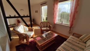 a living room with two chairs a couch and a table at Ferienhaus Sonnenschein in Preetz