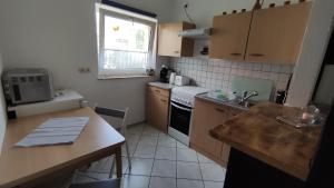 a kitchen with a sink and a stove top oven at Ferienhaus Sonnenschein in Preetz
