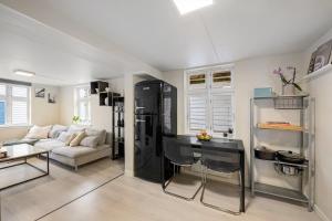 a living room with a couch and a table at Harmony Apartments - Stavanger Sentrum 2 in Stavanger +6 photos