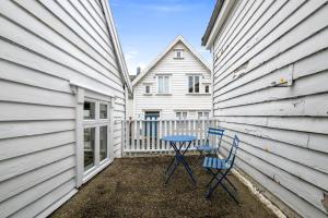 a patio with two chairs and a table in front of a house at Harmony Apartments - Stavanger Sentrum 2 in Stavanger