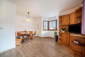 a living room with a table and a dining room at Sonnenparadies Apartement 1 in Saltusio +14 photos