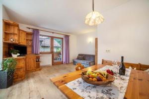 a kitchen with a table with a bowl of fruit on it at Sonnenparadies Apartement 1 in Saltusio