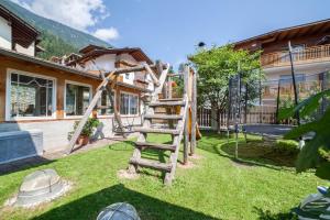 a playground in the backyard of a house at Sonnenparadies Apartement 1 in Saltusio