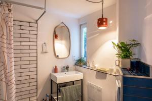 a bathroom with a sink and a mirror at Fewo Sankt Johann I in Konstanz +17 photos