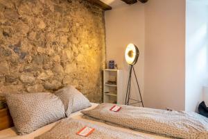a bedroom with a stone wall and a bed at Fewo Sankt Johann I in Konstanz