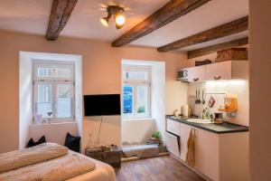 a bedroom with a bed and a kitchen with a sink at Fewo Sankt Johann I in Konstanz
