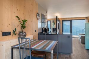 a kitchen with a table and a dining room at Aumia Apartment Turmalin in Völs am Schlern