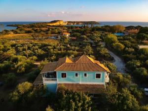 an aerial view of a house with the ocean in the background at Areti Orfeas Budget Studio in Vasilikos +18 photos