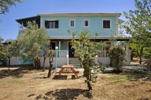 a house with a picnic table in front of it at Areti Orfeas Budget Studio in Vasilikos