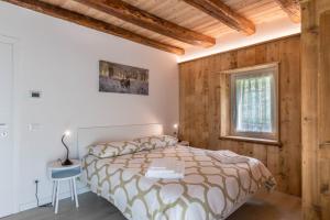 a bedroom with a bed and a table and a window at Casa Barona in Valfloriana