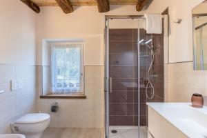 a bathroom with a shower and a toilet and a sink at Casa Barona in Valfloriana +21 photos