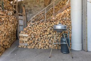 a stack of fire wood next to a staircase at Casa Barona in Valfloriana