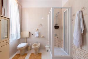 a bathroom with a toilet and a sink and a shower at Casa Viola 1 piano 100 mt dal mare in Trappeto +22 photos