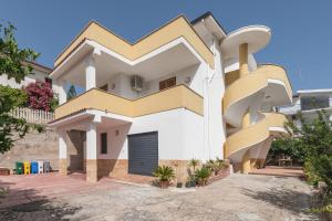a house with a spiral staircase on the side of it at Casa Viola 1 piano 100 mt dal mare in Trappeto