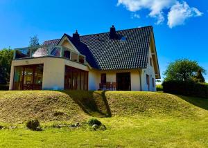 a house sitting on top of a grassy hill at Schwalbennest in Buschvitz