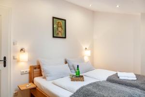 a bedroom with a bed with a bottle of wine on it at Xaver in Rottenbuch