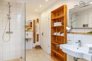 a bathroom with a sink and a shower at Xaver in Rottenbuch +37 photos