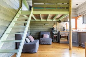 a room with a staircase in a tiny house at La Cabane Perchée in Vert