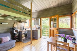 a kitchen and dining room of a tiny house at La Cabane Perchée in Vert