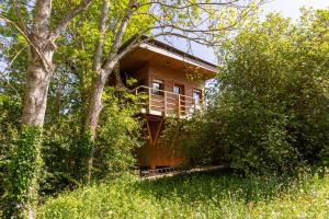 a wooden house in the middle of a forest at La Cabane Perchée in Vert +20 photos