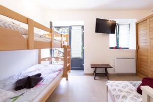 a bedroom with two bunk beds and a flat screen tv at Chalet Belamy Studio 1 in Courchevel