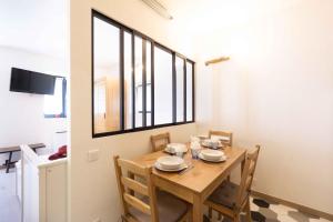 a dining room with a wooden table and a window at Chalet Belamy Studio 1 in Courchevel +4 photos
