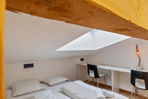 a bedroom with a bed and a desk with two chairs at Haus Excelsior Top 38 in Seefeld in Tirol