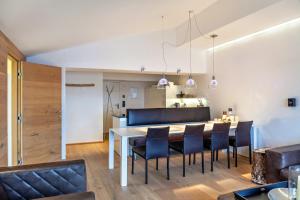 a kitchen and dining room with a table and chairs at Haus Excelsior Top 38 in Seefeld in Tirol