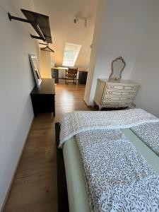 a bedroom with a bed and a dining room at Casa Lenny and Friends in Anzing