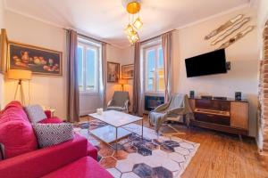 a living room with a red couch and a tv at Contessa di Corfu i in Corfu