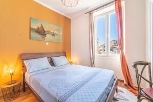 a bedroom with a bed and a large window at Contessa di Corfu i in Corfu