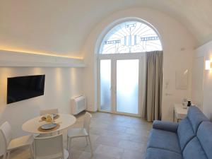 a living room with a blue couch and a table at Syrenia Home in Vico Equense