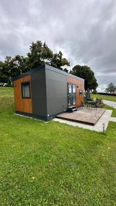 a small house in a field with a deck at Haus Laura in Untergriesbach +12 photos