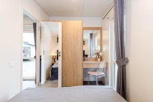 a bedroom with a door leading to a bathroom at Haus Laura in Untergriesbach