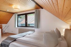 a bedroom with a large bed and a window at Ferienwohnung Glashütte in Sankt Märgen